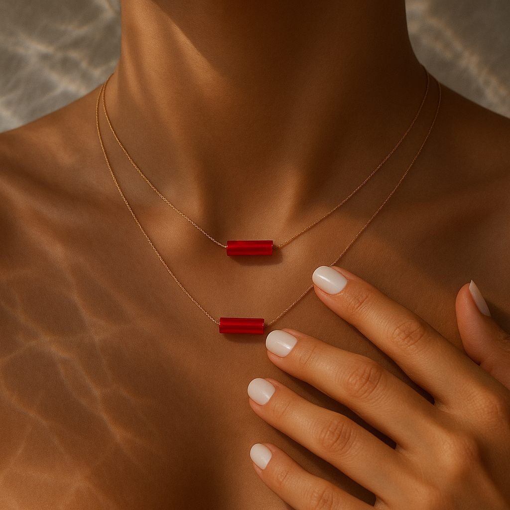 Necklace with carnelian stone pendants on a person's neck gold shown layered